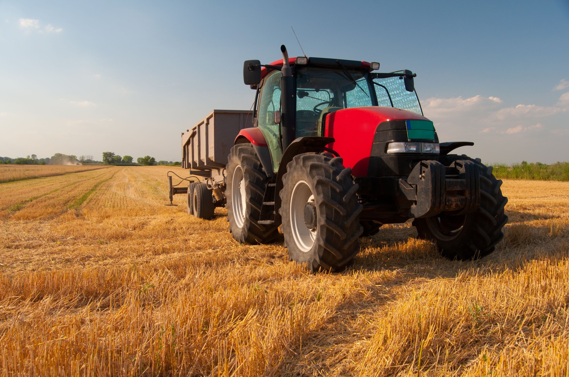 Tractor on the agricultural field during harvest